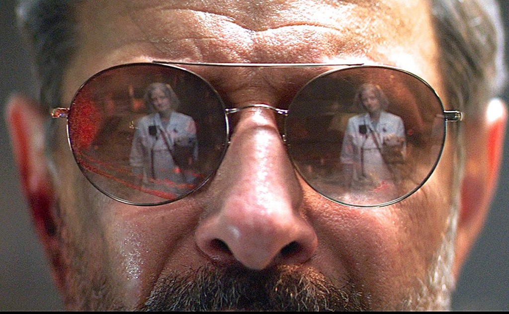Cyberpunk Goldblum: The Nurse reflected in the Wolf-King's bloodstained mirrorshades